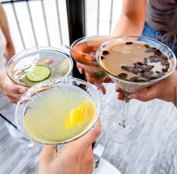 A sophisticated cocktail in a chilled glass with fresh fruit garnish.