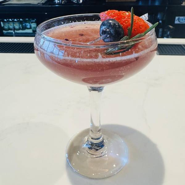 A sparkling cocktail fruit garnish.