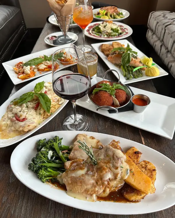 A beautifully plated Italian entrée featuring pasta, seafood, and fresh herbs.