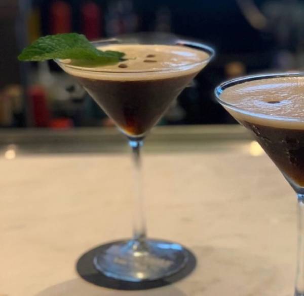 Espresso martinis garnished with mint leaves on the bar at Galliano Fulton.