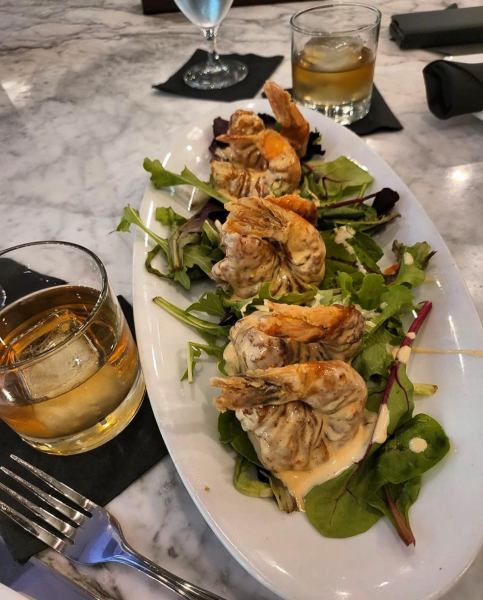 Plated seafood dish with greens and creamy sauce