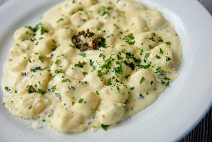 Plate of creamy Italian pasta with herbs.