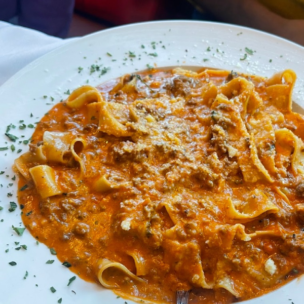 Close-up of richly sauced, handmade Italian pasta.
