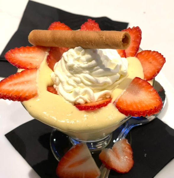 Italian dessert with whipped cream and strawberries.